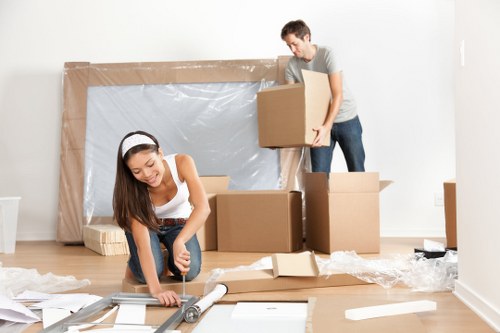 Professional movers handling office equipment